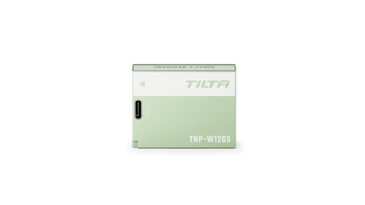 Tilta TNP-W126S battery in Ash Green laid flat, showing the 1050mAh 7.77Wh capacity marking on the top face