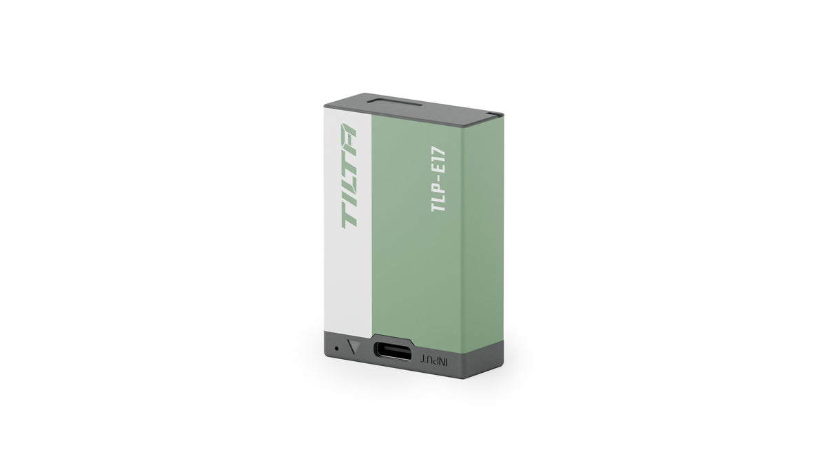 Tilta TLP-E17 950mAh camera battery in Ash Green, three-quarter view showing the USB-C input port on the front edge