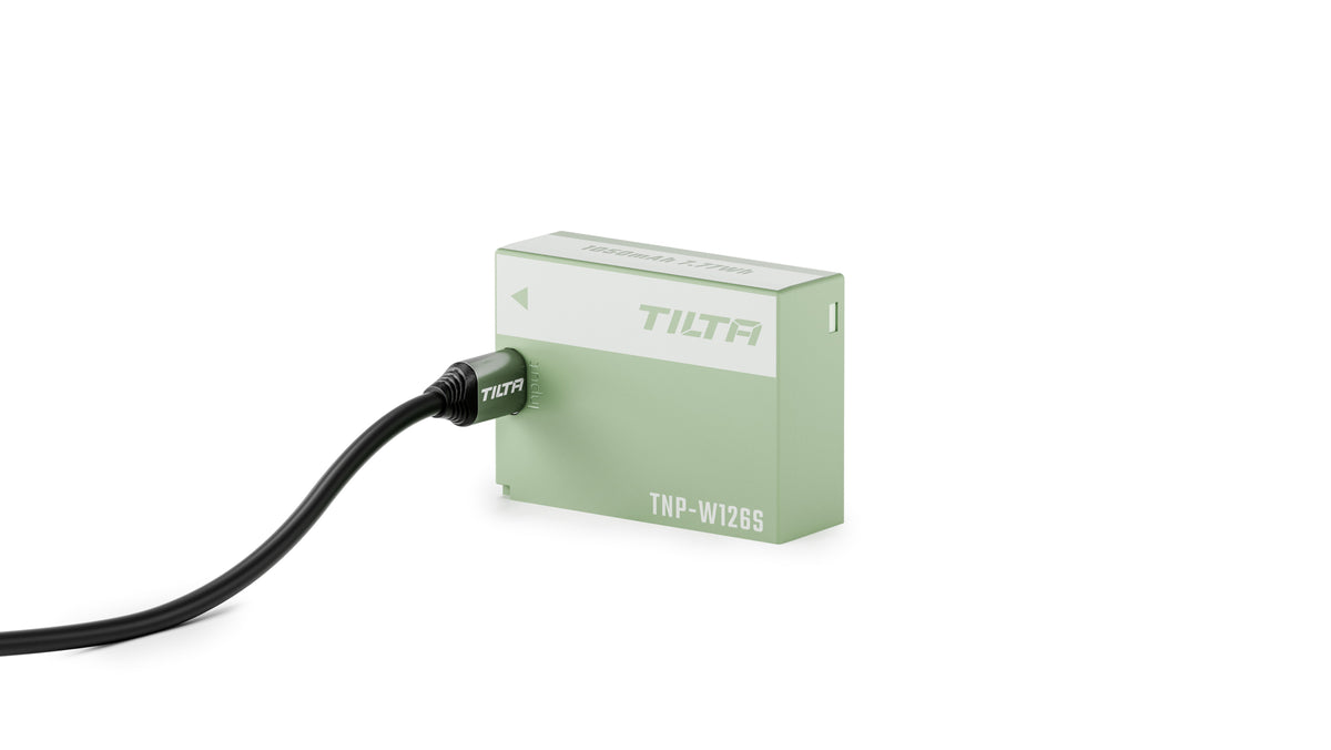 Tilta TNP-W126S battery in Ash Green charging with a USB-C cable plugged into its input port
