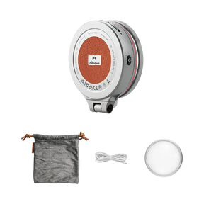 Harlowe Sol 5 XM light: silver body, orange center logo, pouch, cable, diffuser. Mobile photography accessory.